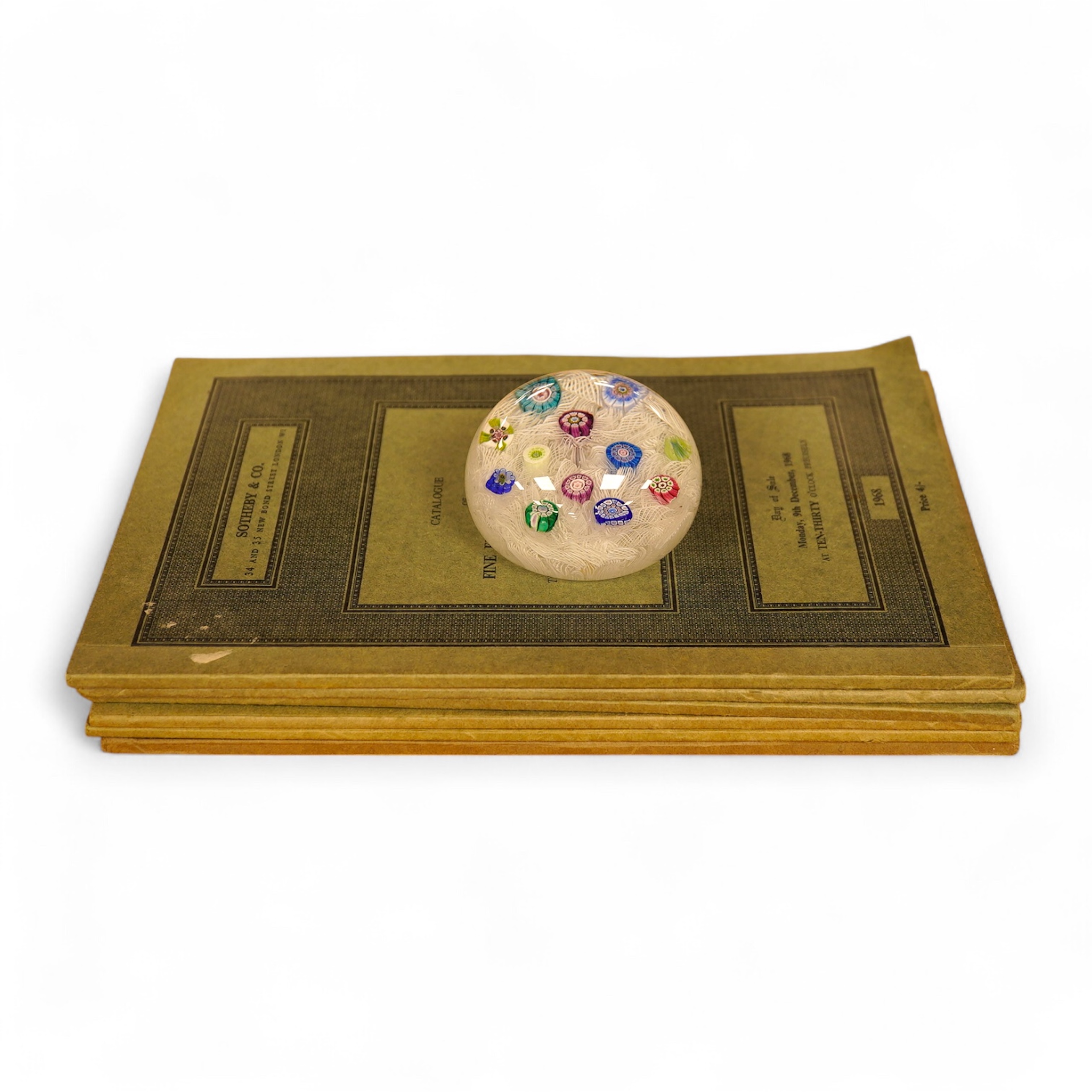 A Perthshire millefiori paperweight, 6.5cm in diameter, together with related Sotheby’s catalogues